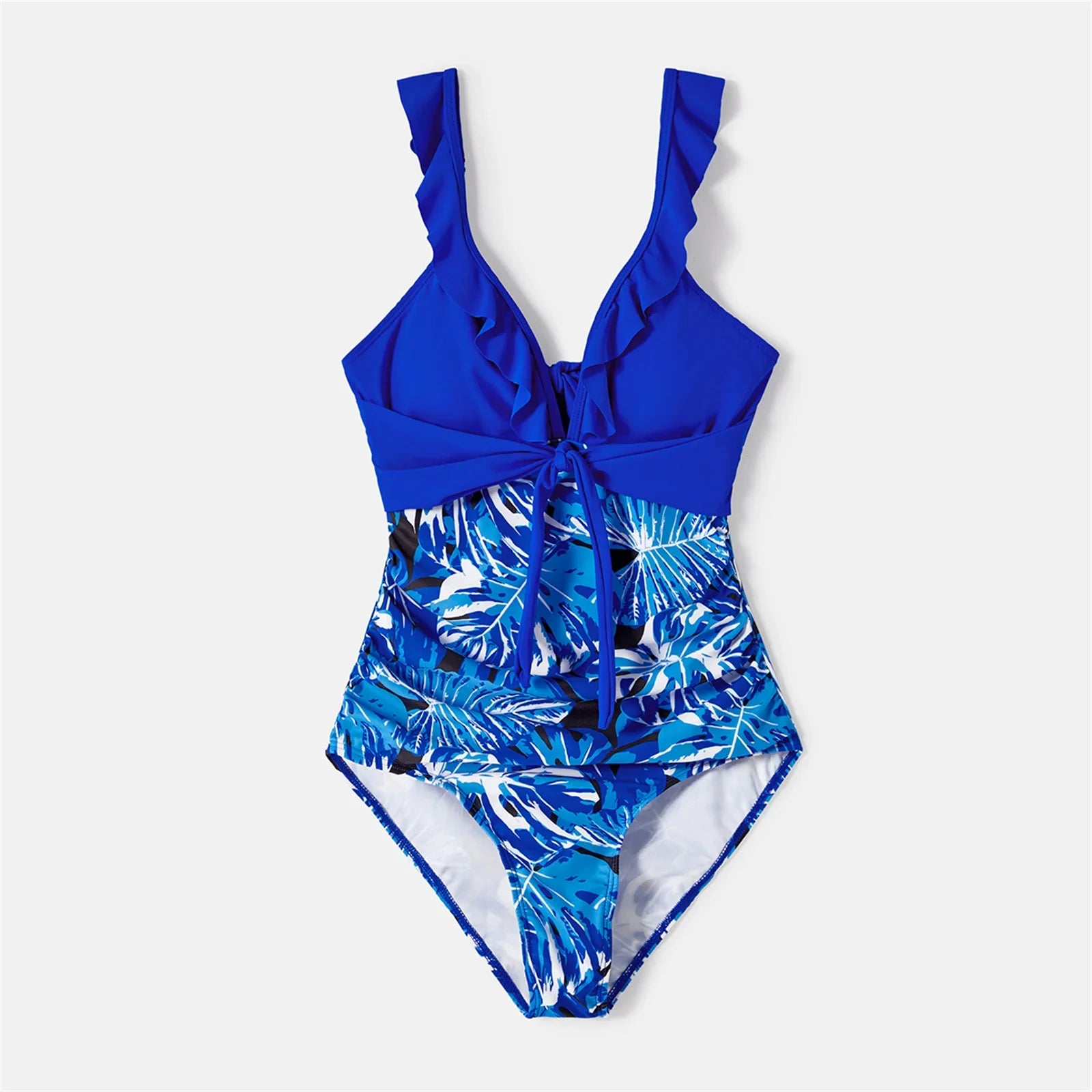 Matching family outfits: father's swim trunks, mother's ruffle swimsuit, and children's tropical swimwear.