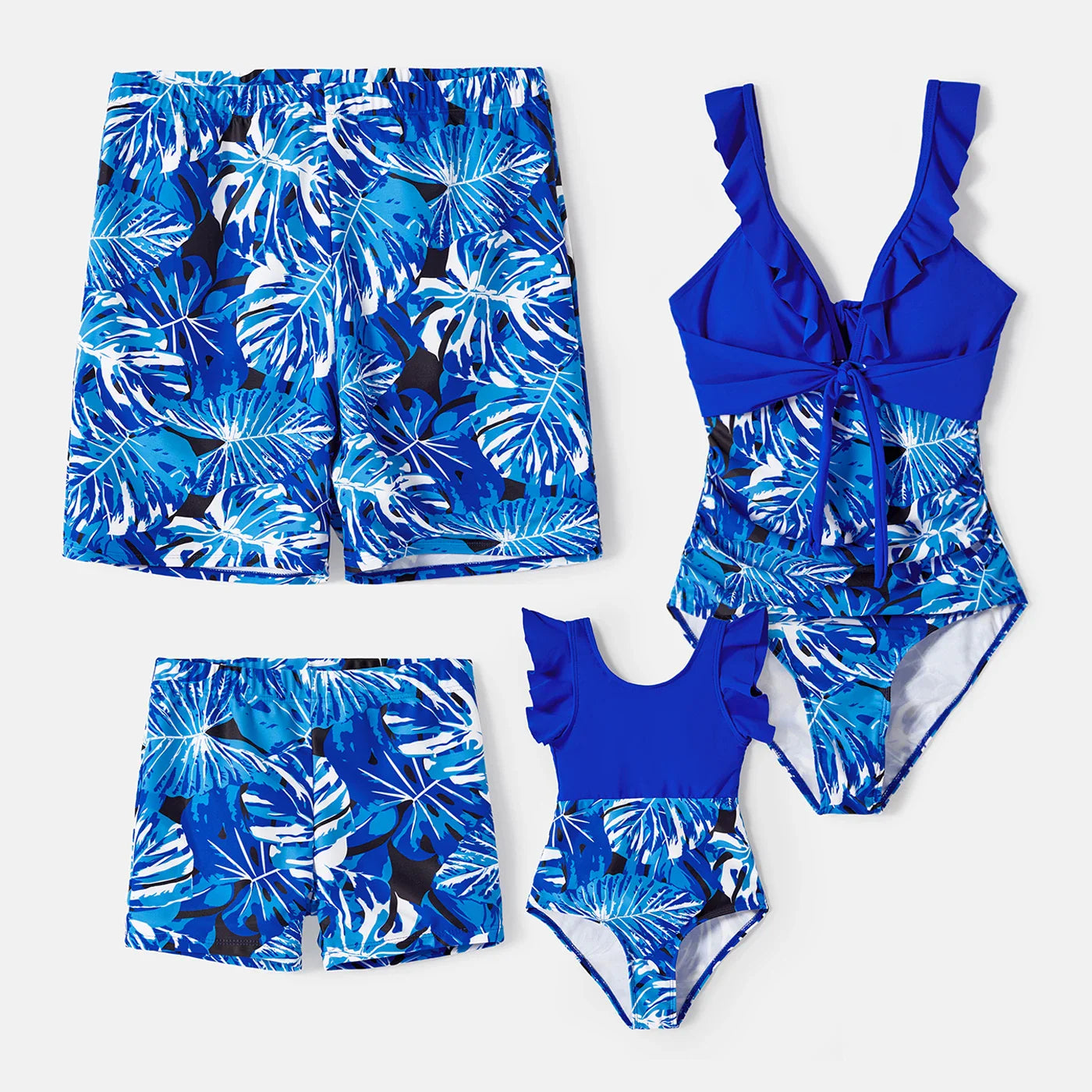 Happy family in tropical leaf print swimsuits, enjoying pool time, perfect for summer fashion.