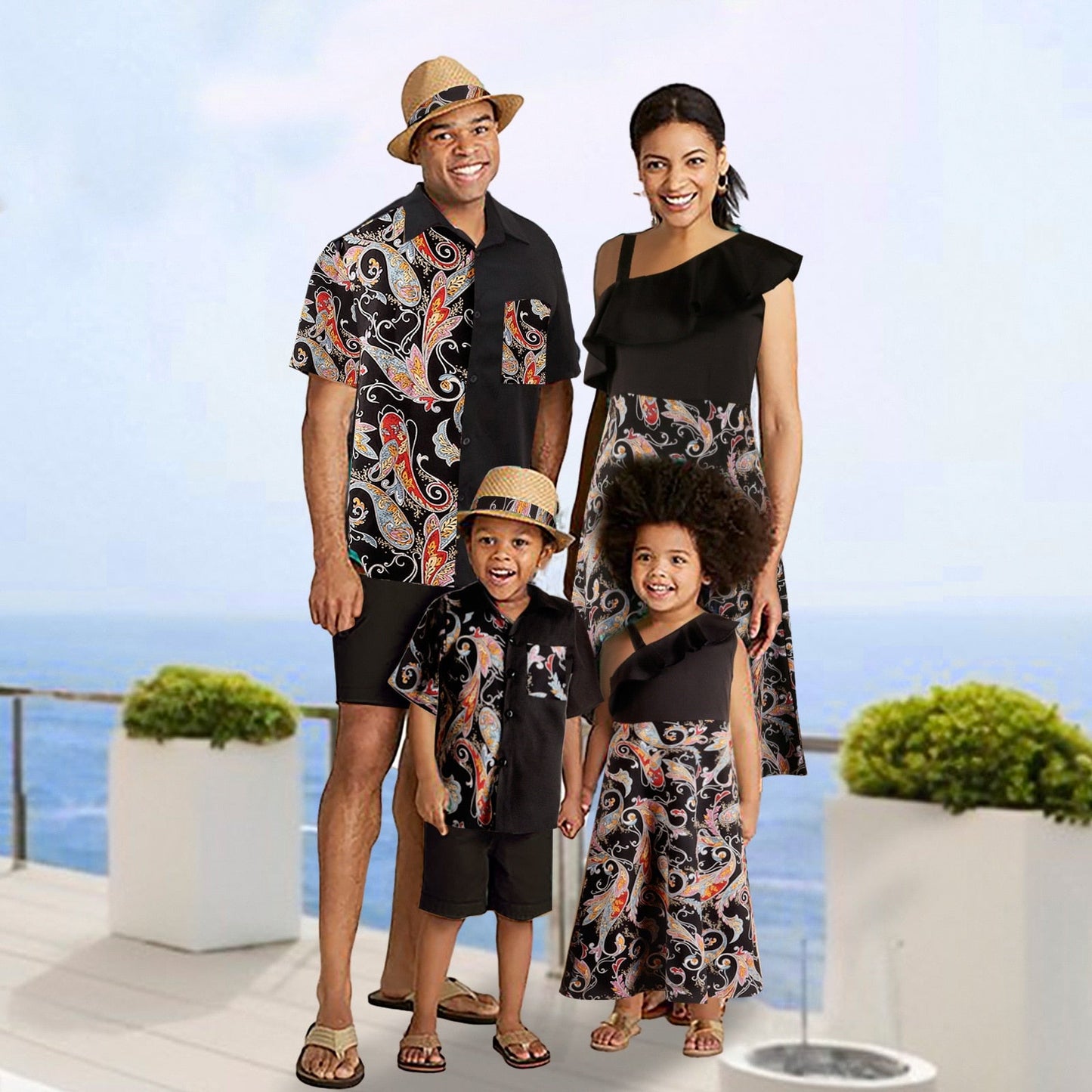 Family matching vacation outfits in modern black textured fabric, parents and baby dressed casually.