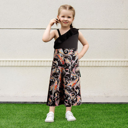 Elegant family of three in modern black textured matching outfits, perfect for any vacation.