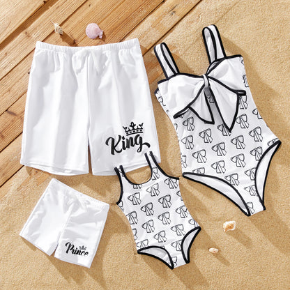 Family matching white swimwear set; bow swimsuit for mom/daughter, drawstring trunks for dad/son.