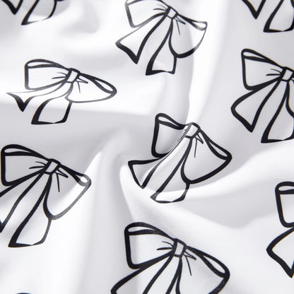 Matching white swimwear set featuring a bow detail on the ladies' suit and practical drawstring trunks.