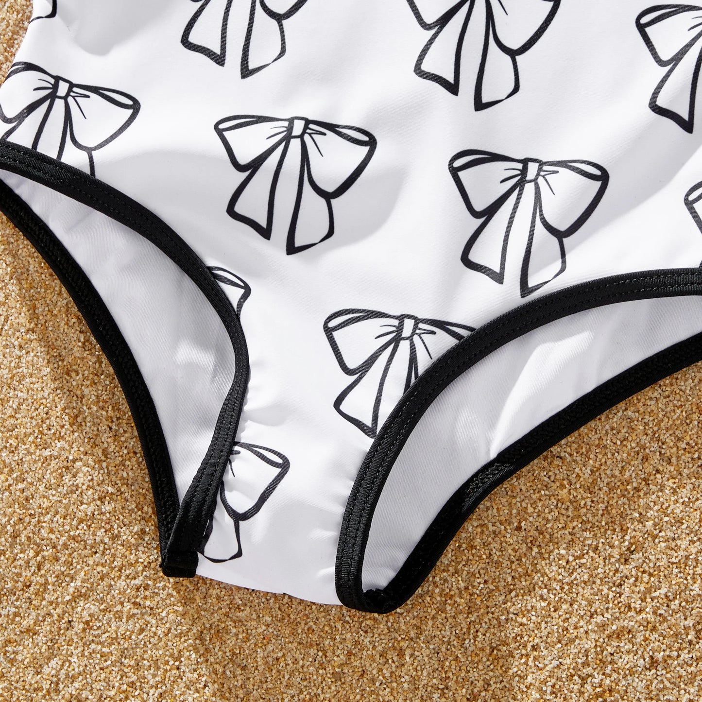 White drawstring trunks for men, designed to match family's letter print swimwear.