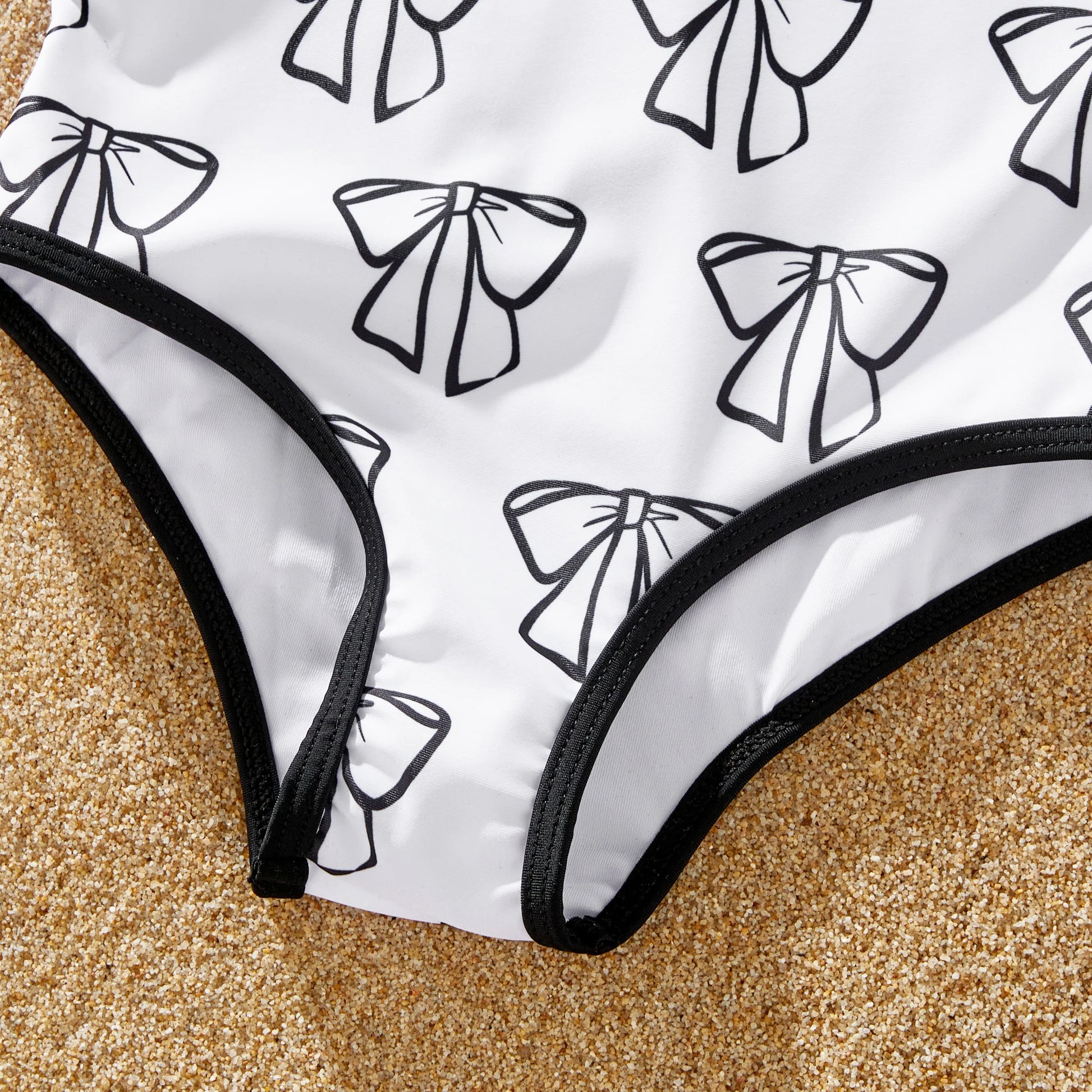 White drawstring trunks for men, designed to match family's letter print swimwear.
