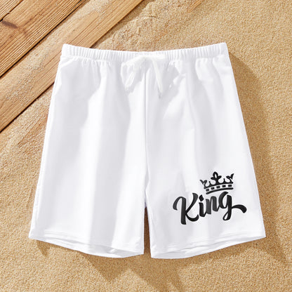 Family matching swimwear: white bow swimsuit for women, white drawstring trunks for men.