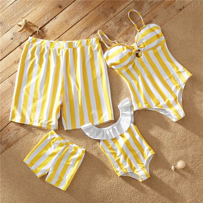 Close-up of vibrant yellow striped family matching swimsuits fabric, chinlon spandex for comfortable fit.