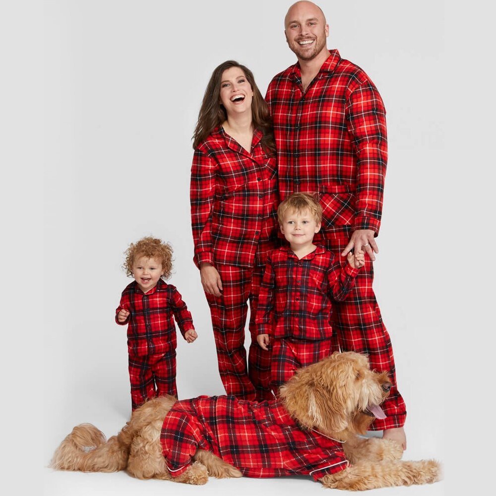 Smiling family in festive plaid matching pajamas set, perfect for Christmas photos and winter sleepwear.