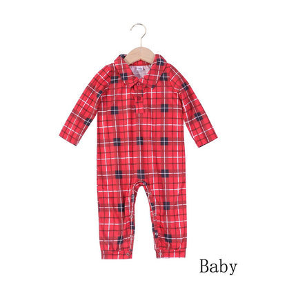 Cute dog wearing a matching red and black plaid pet pajama, coordinating with family Christmas sleepwear.