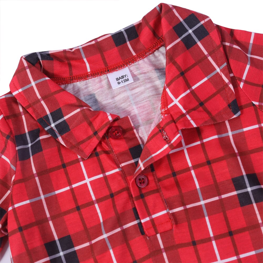 Baby in soft plaid footed pajamas, part of a matching family set for holiday and winter sleepwear.