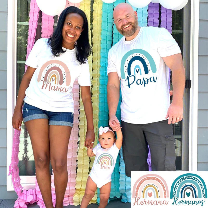 Stack of folded rainbow family matching t-shirts, soft milk silk spandex, ready for family summer adventures.