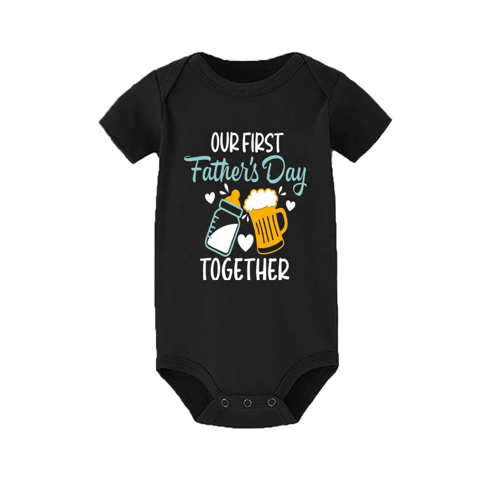 Close-up of 'First Father's Day' print on matching dad t-shirt and baby romper