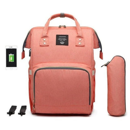 Lifestyle shot: Fit-All Baby Diaper Backpack beside a baby car seat, ready for travel