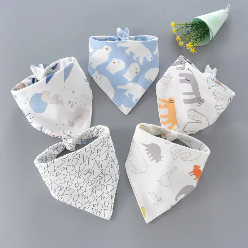 Close-up of a blue cotton baby bib with a cute cartoon animal, absorbent and soft for feeding