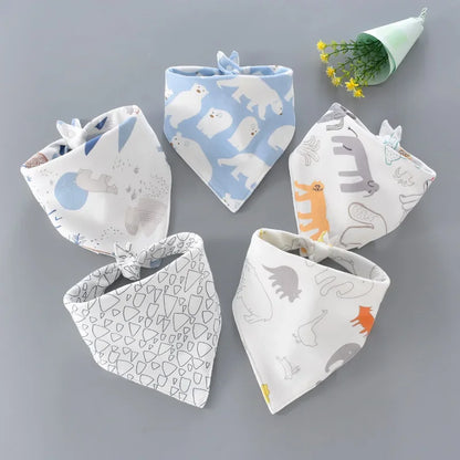 Close-up of a blue cotton baby bib with a cute cartoon animal, absorbent and soft for feeding