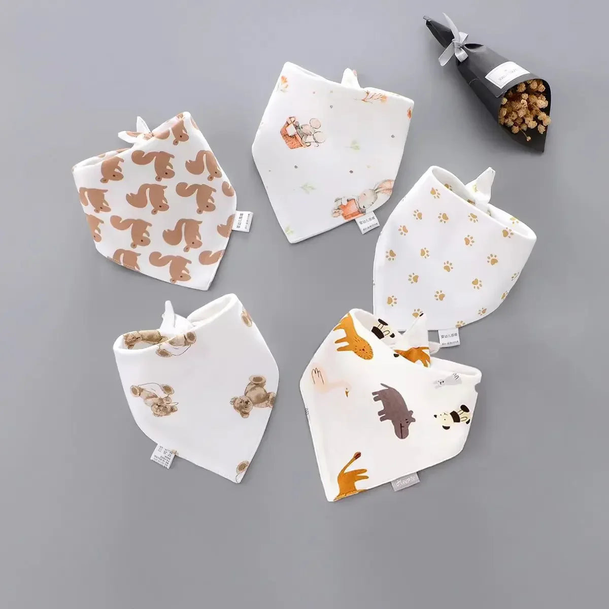 Assorted cartoon baby bibs displayed neatly, showcasing the variety in the 5-pack