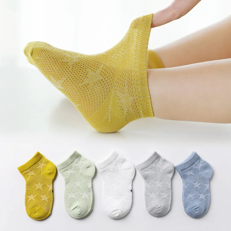 Breathable cotton baby socks with star designs, showing the soft texture of the fabric.