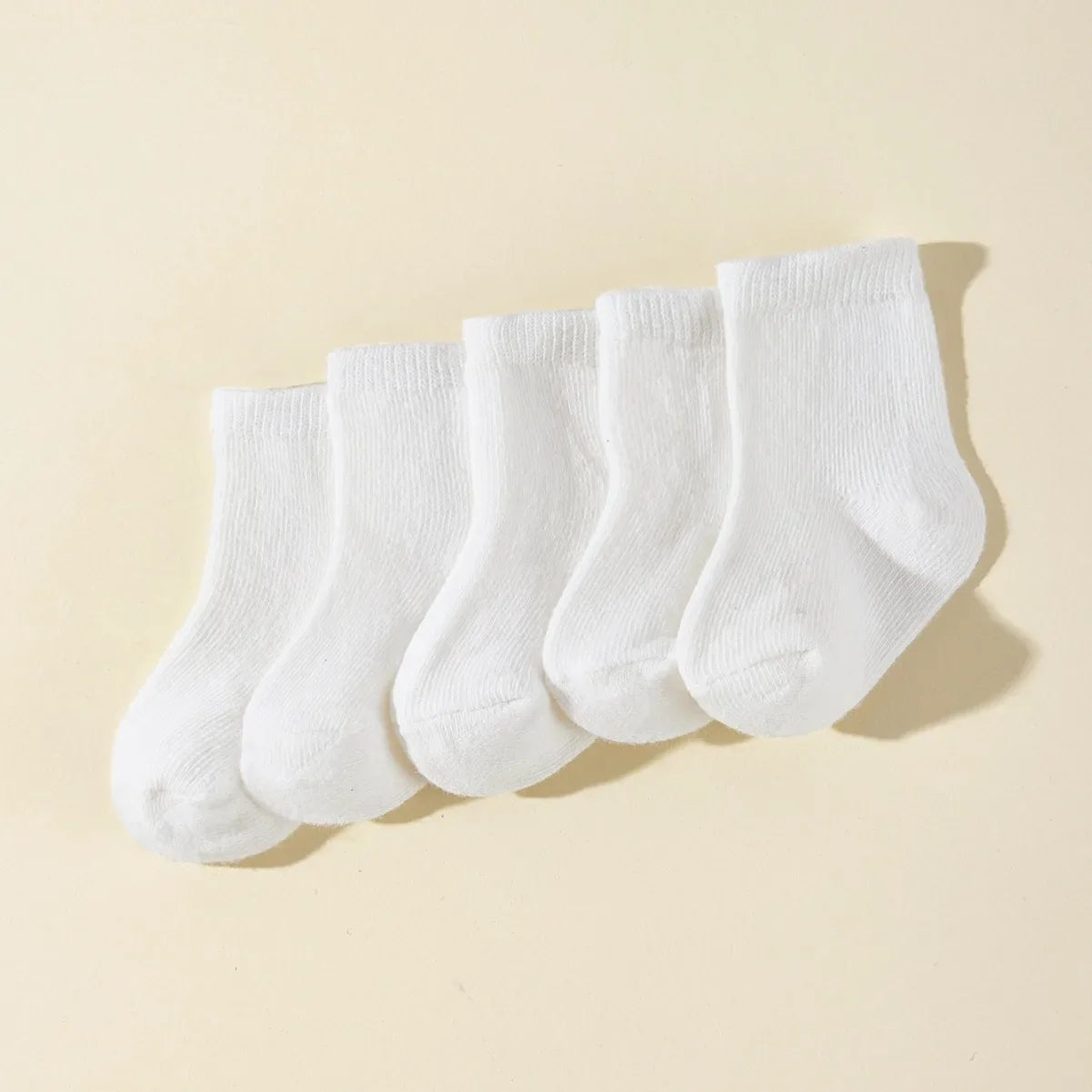 Pack of five pairs of durable, breathable cotton baby socks for everyday infant clothing.