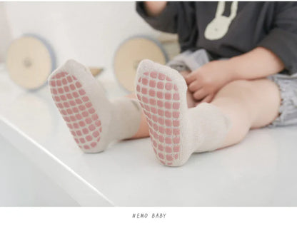 Colorful anti-slip baby socks, cotton rich with engaging cartoon patterns, unisex fit