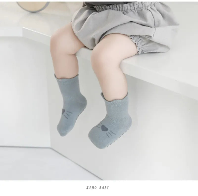 Five pairs of soft, breathable anti-slip cotton baby socks with cheerful cartoon prints