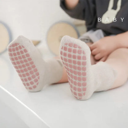 Collection of five anti-slip cartoon toddler socks in various unisex designs and colors
