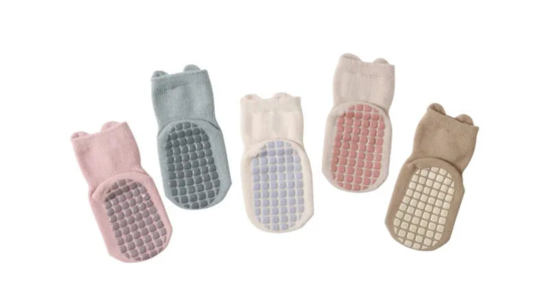 Detail of the anti-slip silicone dots on the sole of a cartoon baby sock