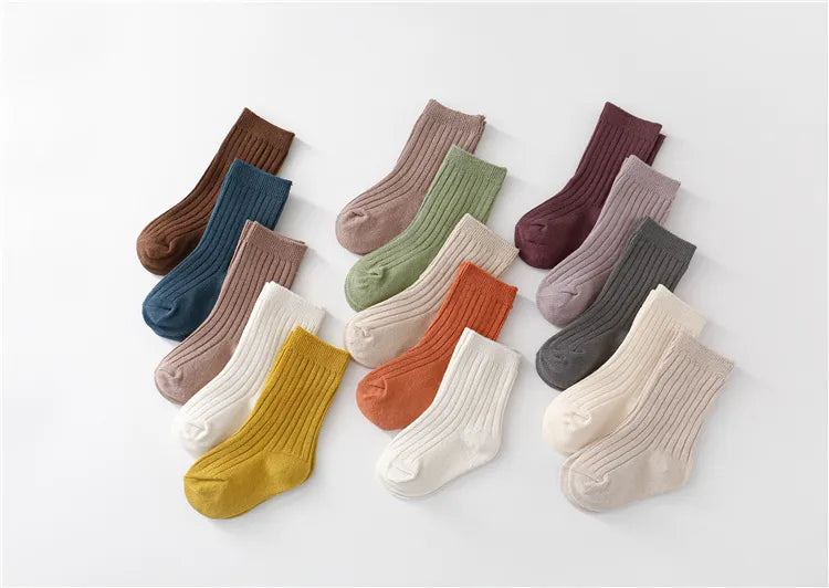 Variety of five pairs of cotton blend unisex socks, essential baby accessories for comfort.