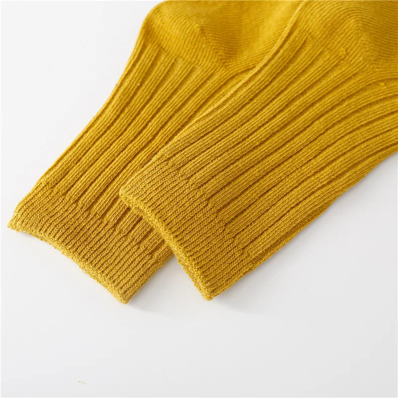 Top view of five pairs of breathable cotton blend kids socks, neatly arranged for comfort.