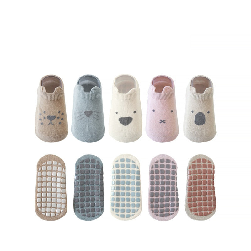 Children's non-skid ankle socks, multi-colored and slip-resistant for safe play.