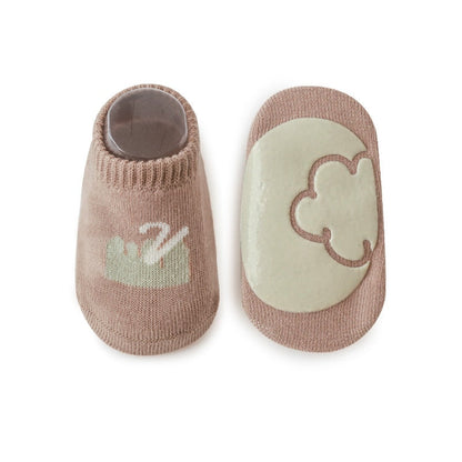 Assorted non-skid ankle socks for kids, designed for comfort and preventing slips.