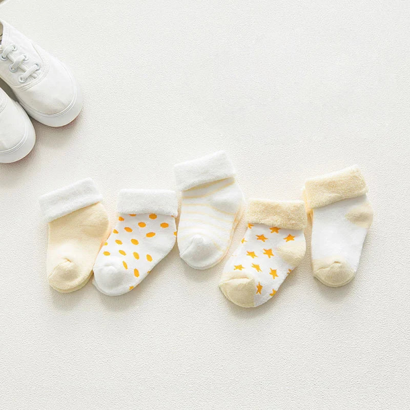 Unisex baby cotton cartoon socks in a stack, highlighting their thickness and softness.
