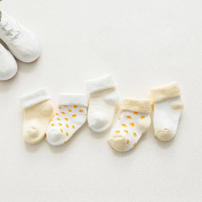 Unisex baby cotton cartoon socks in a stack, highlighting their thickness and softness.