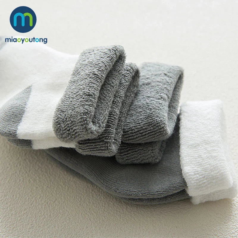 Detail of the soft texture and thick knit of a white unisex baby cotton cartoon sock.