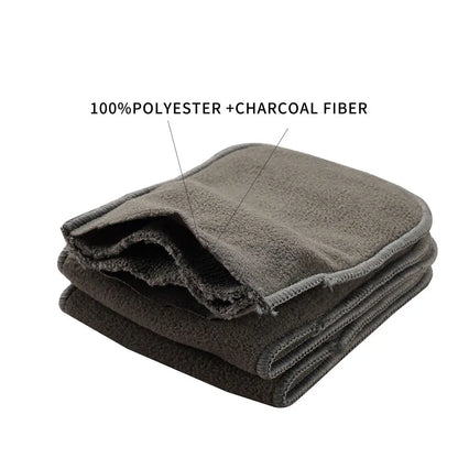 Close-up of a charcoal bamboo nappy insert, showcasing its soft, absorbent layers for babies