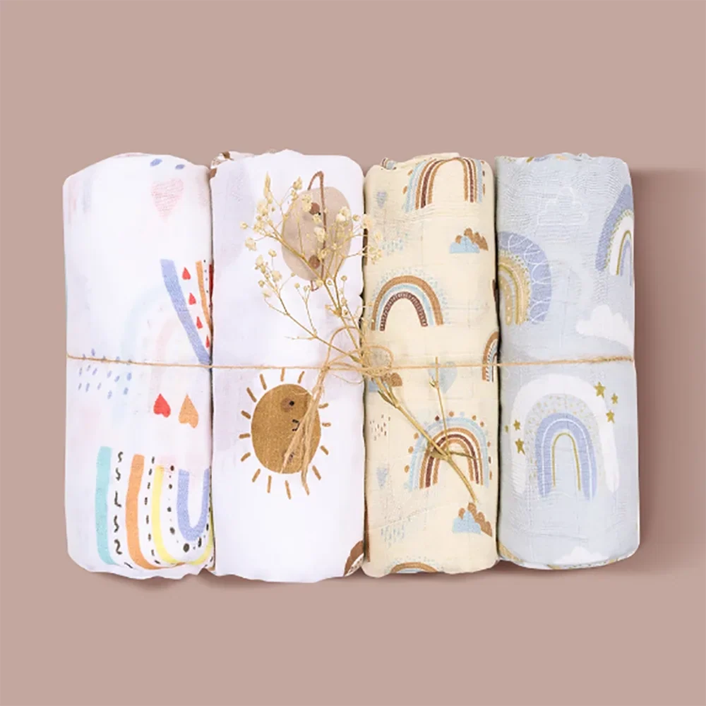 Four-pack of soft bamboo cotton muslin swaddle blankets in various patterns, newborn essentials