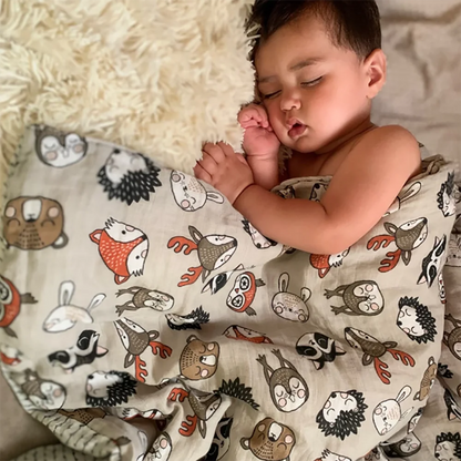 Baby wrapped comfortably in a multi-use bamboo cotton muslin swaddle blanket, soft infant care
