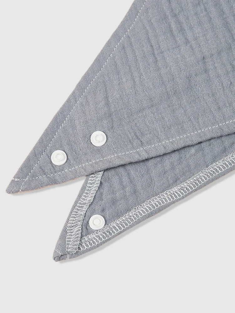 Baby wearing a cute organic cotton bandana bib, super absorbent and gentle on skin