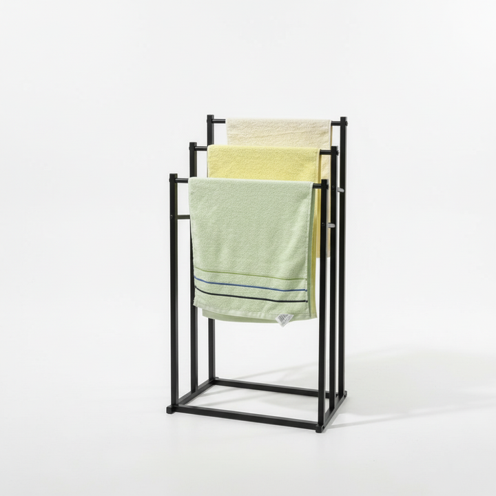 Elegant metal towel holder, freestanding design for stylish bathroom decor and convenient towel storage.