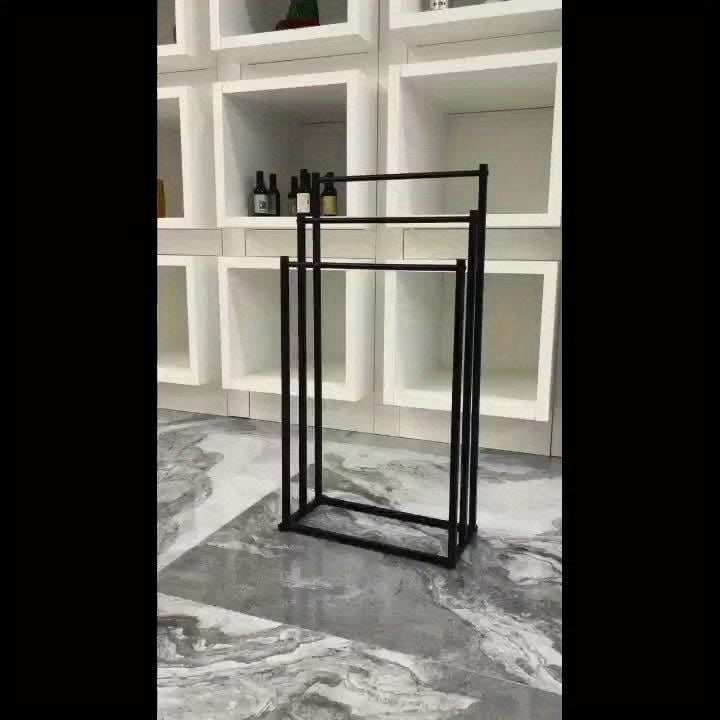 NeatRack freestanding steel towel rack, ideal for bathroom organization, holding multiple towels cleanly.