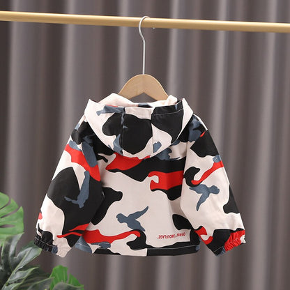 Texture detail of the soft cotton material on a camouflage hooded zip-up jacket, toddler-friendly and stylish.