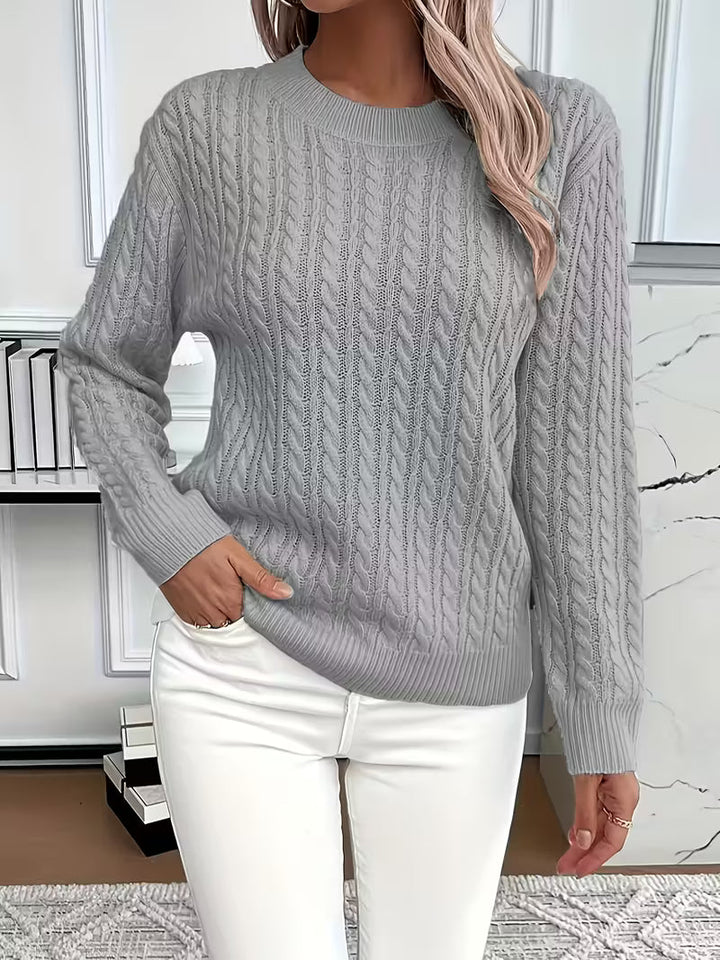 Soft and cozy women's crew neck cable knit sweater, a versatile addition to autumn wardrobes.