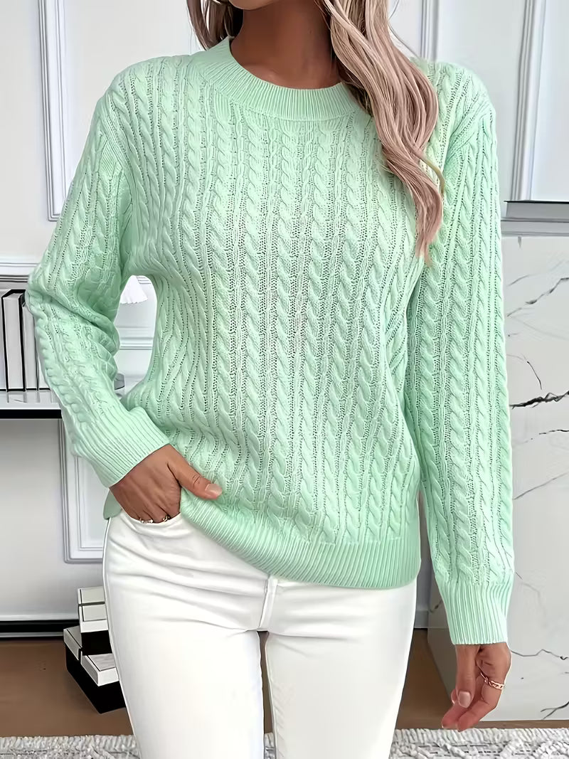 Close-up of the intricate cable knit pattern on a soft women's crew neck jumper, ideal for autumn.