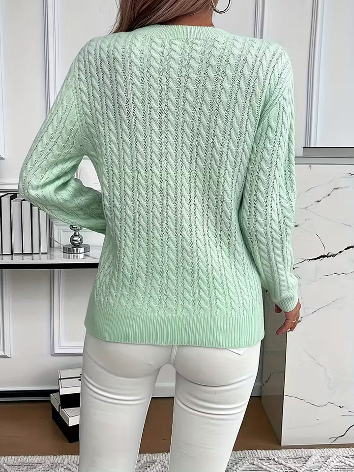 Stylish women's crew neck knitwear sweater for autumn, featuring a classic cable knit design.