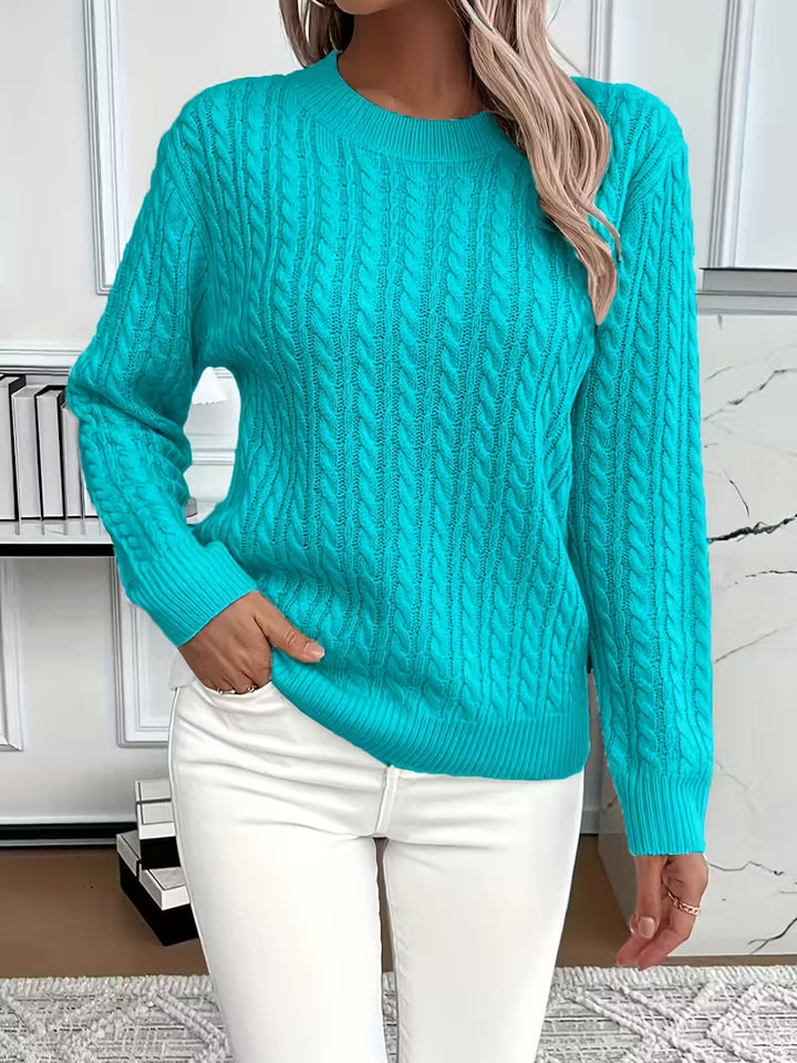 Detail shot of the textured cable knit on a women's crew neck pullover, showcasing quality knitwear.