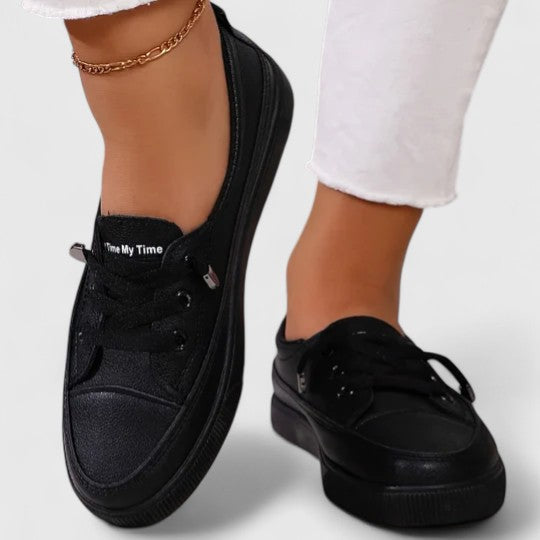 Stylish black women's lightweight walking shoes with orthopedic arch support for comfortable daily wear.