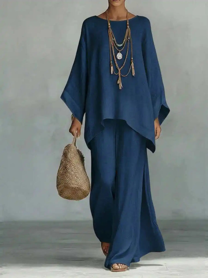 Detail shot of the flowy fabric of the women's asymmetrical top and wide-leg pants set. Soft, comfortable, and chic.