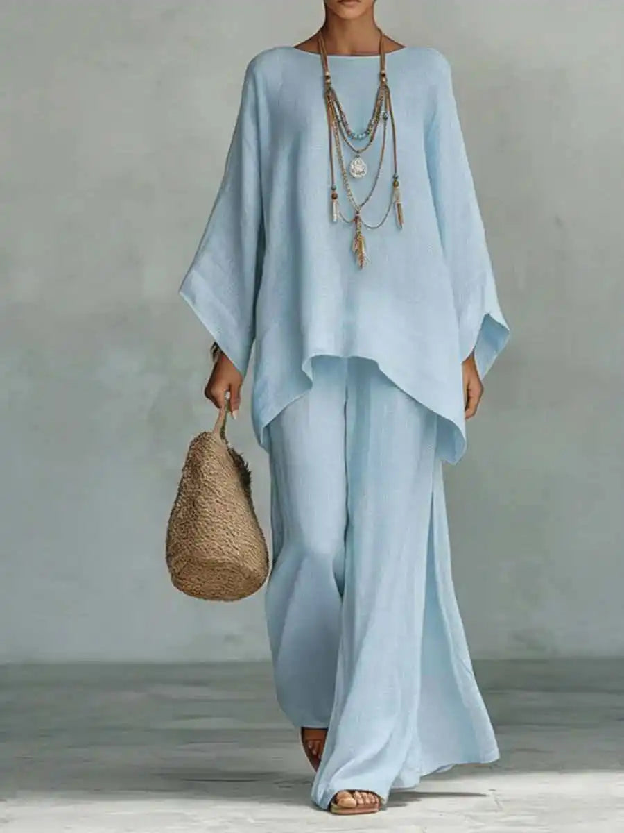 Back view of a women's two-piece set, highlighting the relaxed fit of wide-leg pants and an asymmetrical top. Spring/summer.