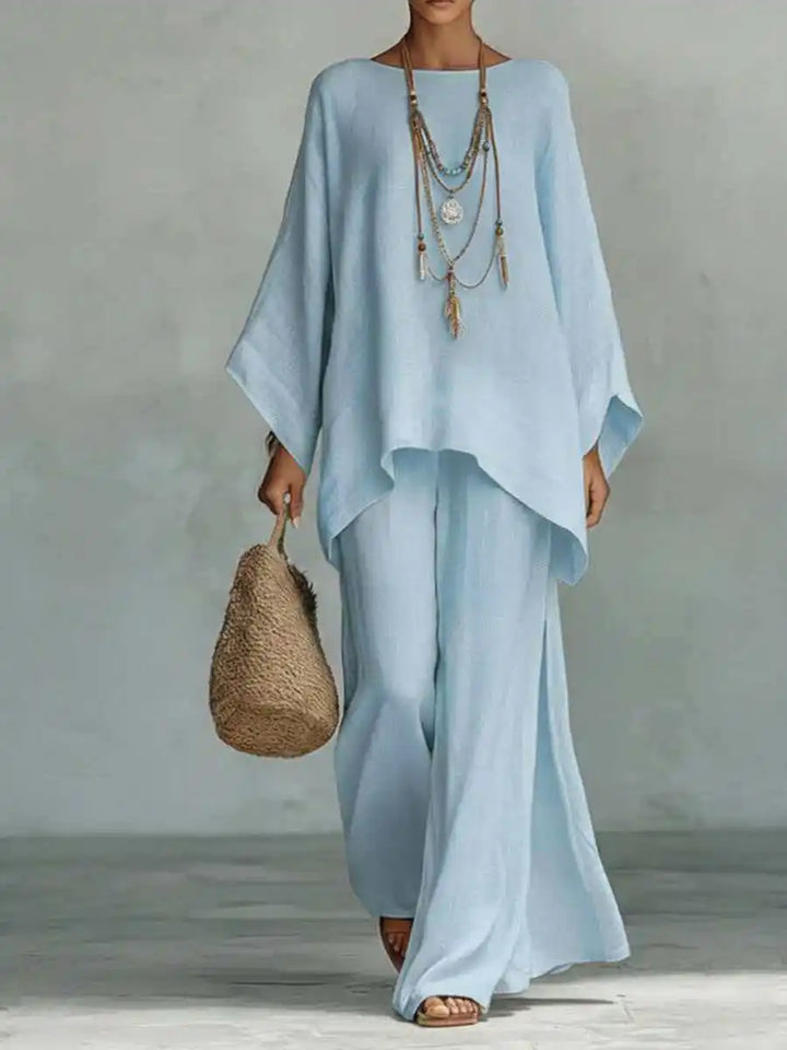 Back view of a women's two-piece set, highlighting the relaxed fit of wide-leg pants and an asymmetrical top. Spring/summer.