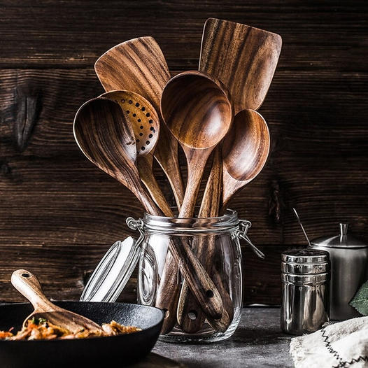 Full set of natural teak wood kitchen utensils, ideal for healthy, sustainable cooking.