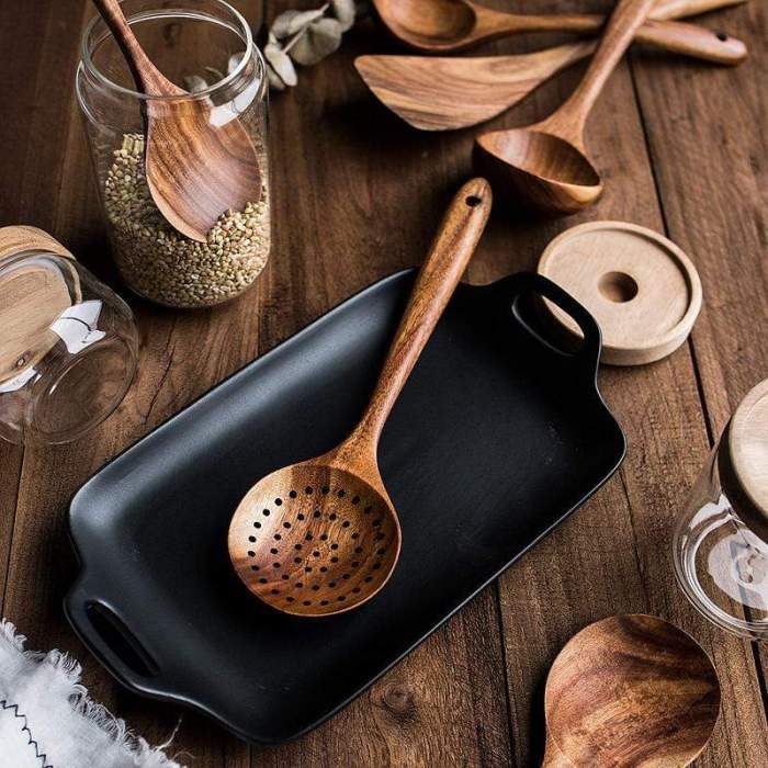 Smooth teak wood spatula from a natural kitchen utensil set, great for non-stick healthy cooking.