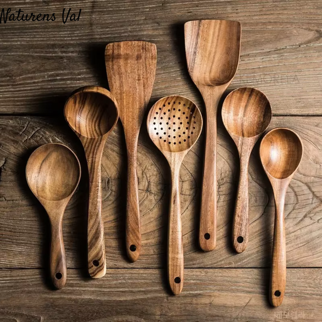 Beautiful natural teak wood grain visible on a full set of eco-friendly kitchen cooking tools.